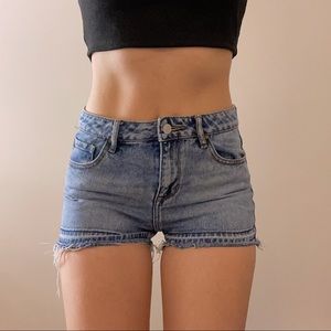 medium wash distressed denim shorts